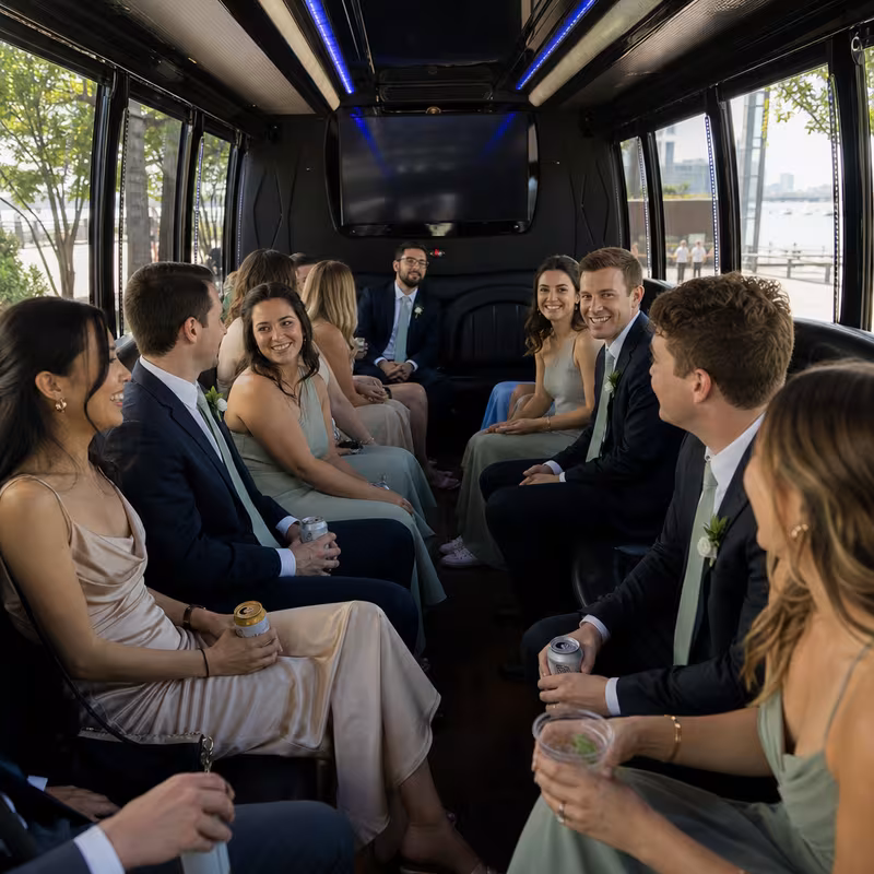 Wedding guests seated inside a Boston party bus