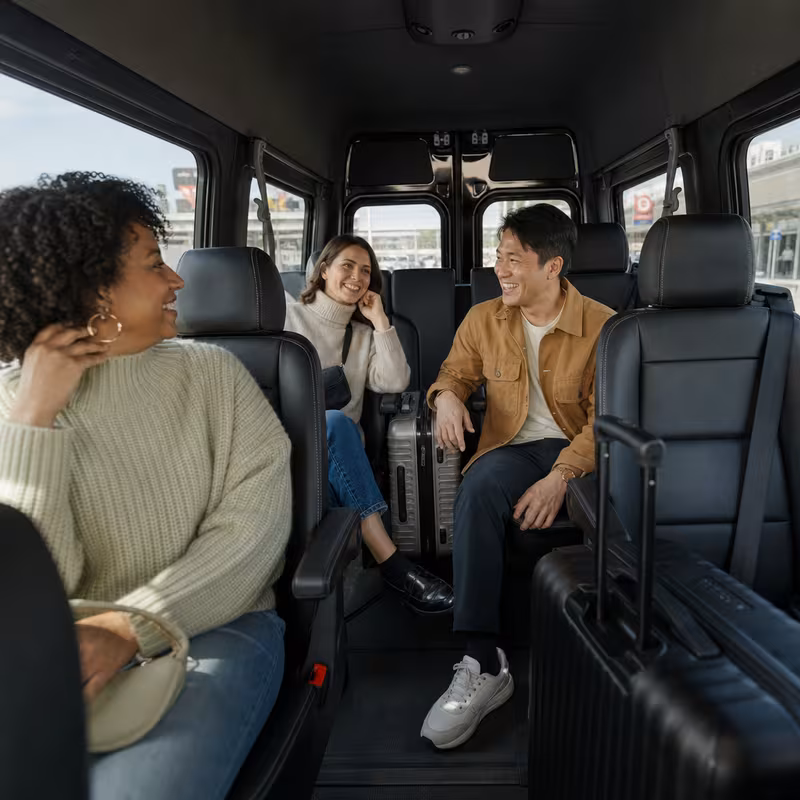 Passengers loading luggage while boarding an Boston group shuttle
