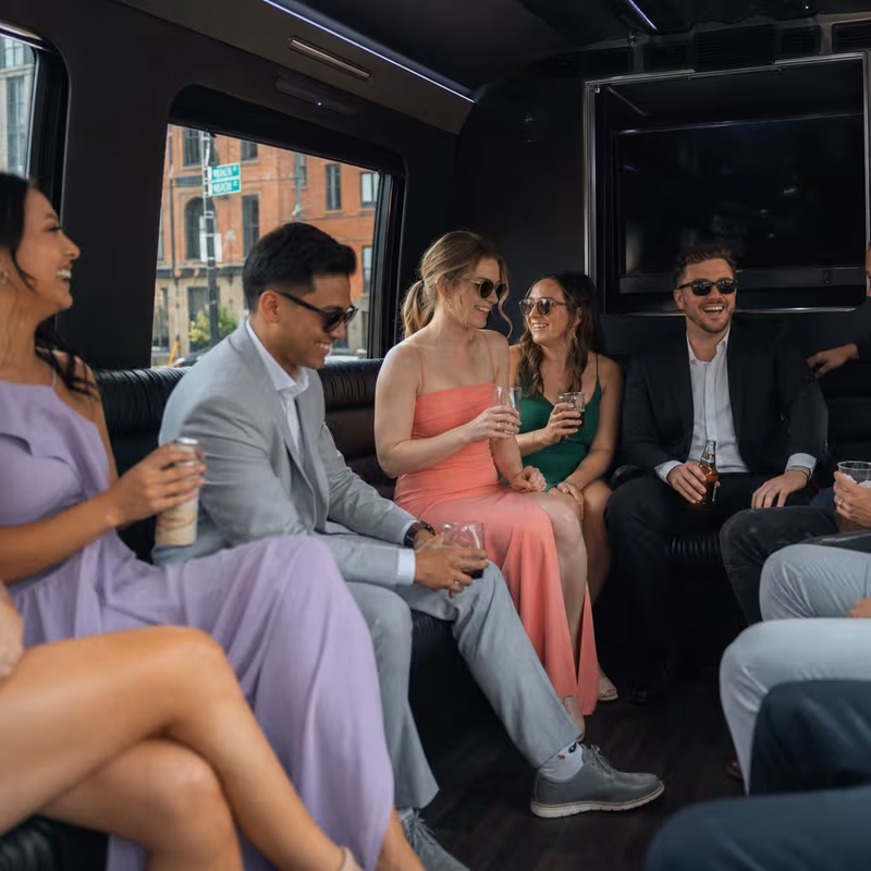 Party bus interior with wraparound leather seating and LED lighting in Boston