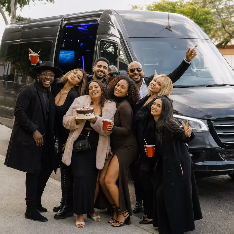 Group boarding a white charter bus for Birthday Transportation transportation in Boston