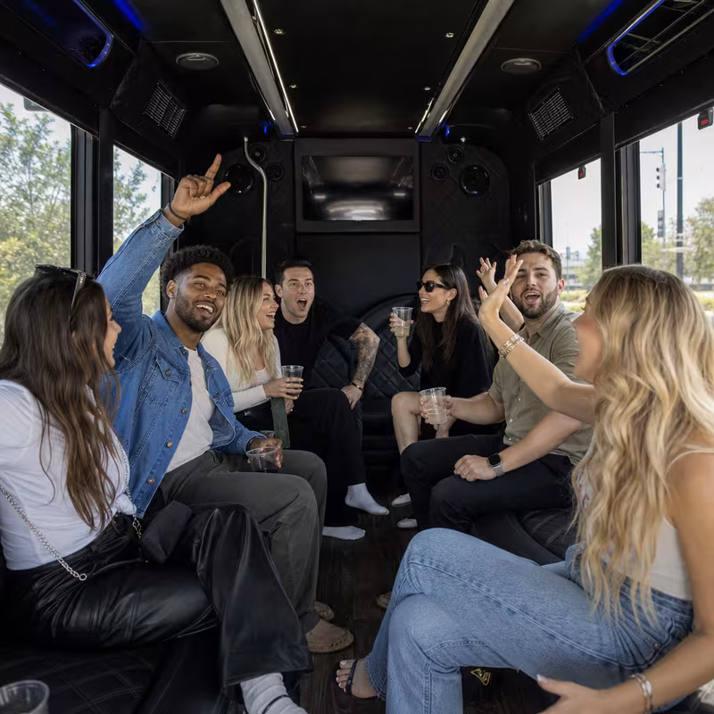 Group boarding a white charter bus for Concert Transportation transportation in Boston