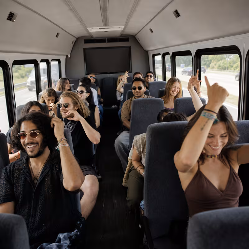 Party bus interior with wraparound leather seating and LED lighting in Boston