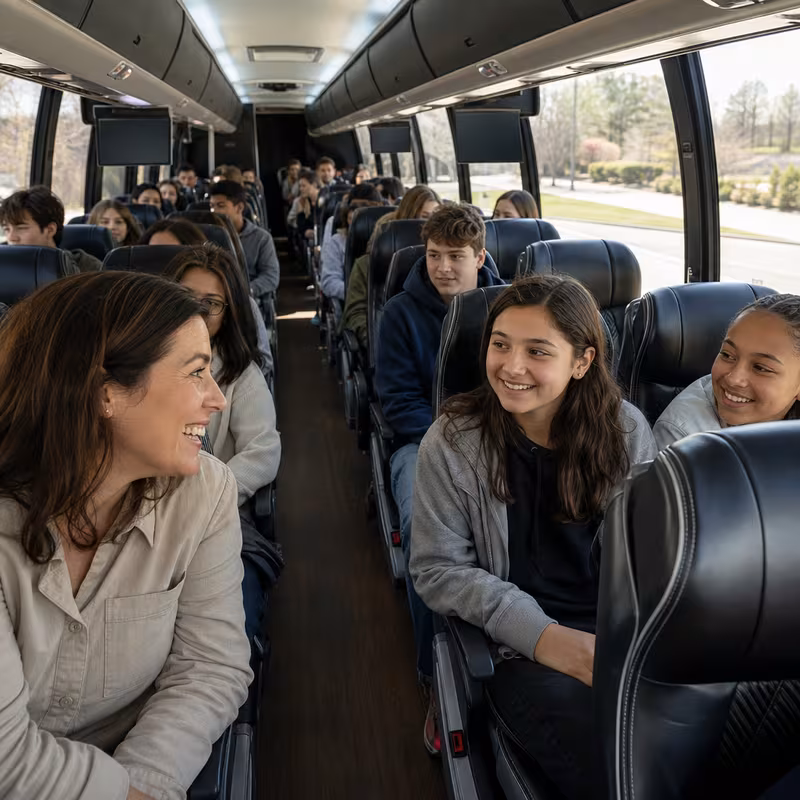 Group boarding a white charter bus for School Transportation transportation in Boston